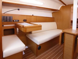 The navigation table & port-side sofa aboard the Jeanneau Sun Odyssey 33i sailing yacht
