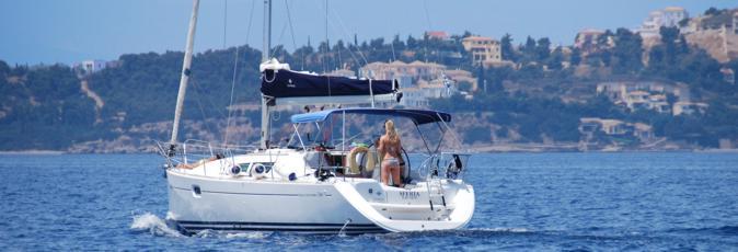 A Greek Sails Sun Odyssey 36i yacht on flotilla makes its way into the Spetses channel heading north west towards the Argolic Gulf
